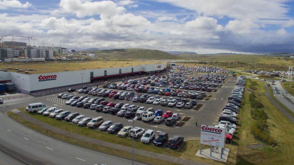 The massive Costco warehouse in Iceland with a packed parking lot, offering great deals on bulk groceries for road trippers